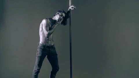 Sexy man pole dancer. Guy does gymnastic exercises on pole dance. Pole dancing Stock Footage 321386026