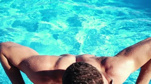 Sexy man in a pool Stock Footage 90910059