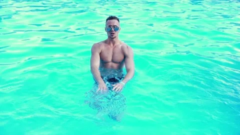 Sexy man in a pool Stock Footage 90910631