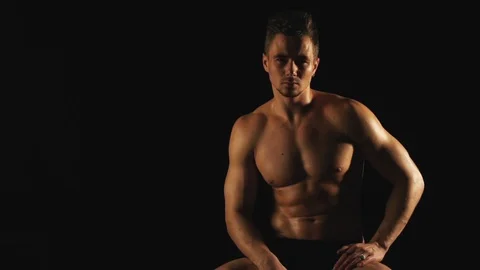 Sexy man posing on black background Видео 100198388