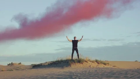 Sexy man is posing in desert Stock Footage 77583165