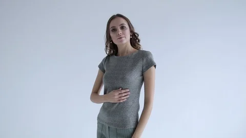 Sexy model with beads posing on white background, slow mo Stock Footage 106282334
