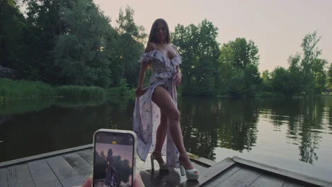 Sexy model posing for the camera on the background of the lake Stock Footage 156294700