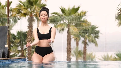 Sexy Model posing by the pool Stock Footage 129470533