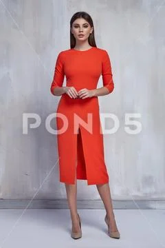 Sexy pretty fashion woman wear skinny orange dress casual trend clothes colle Stock Photos