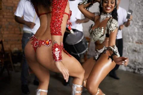 Sexy samba moves. two samba dancers performing in a carnival with their band. Stock Photos