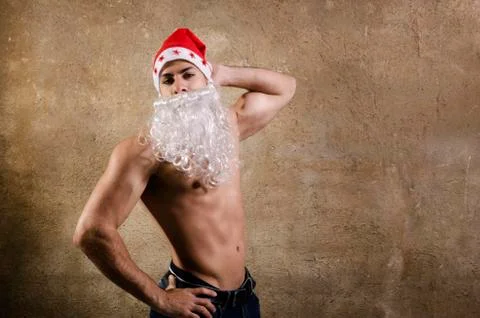 Sexy santa posing on wall background Stock Photos