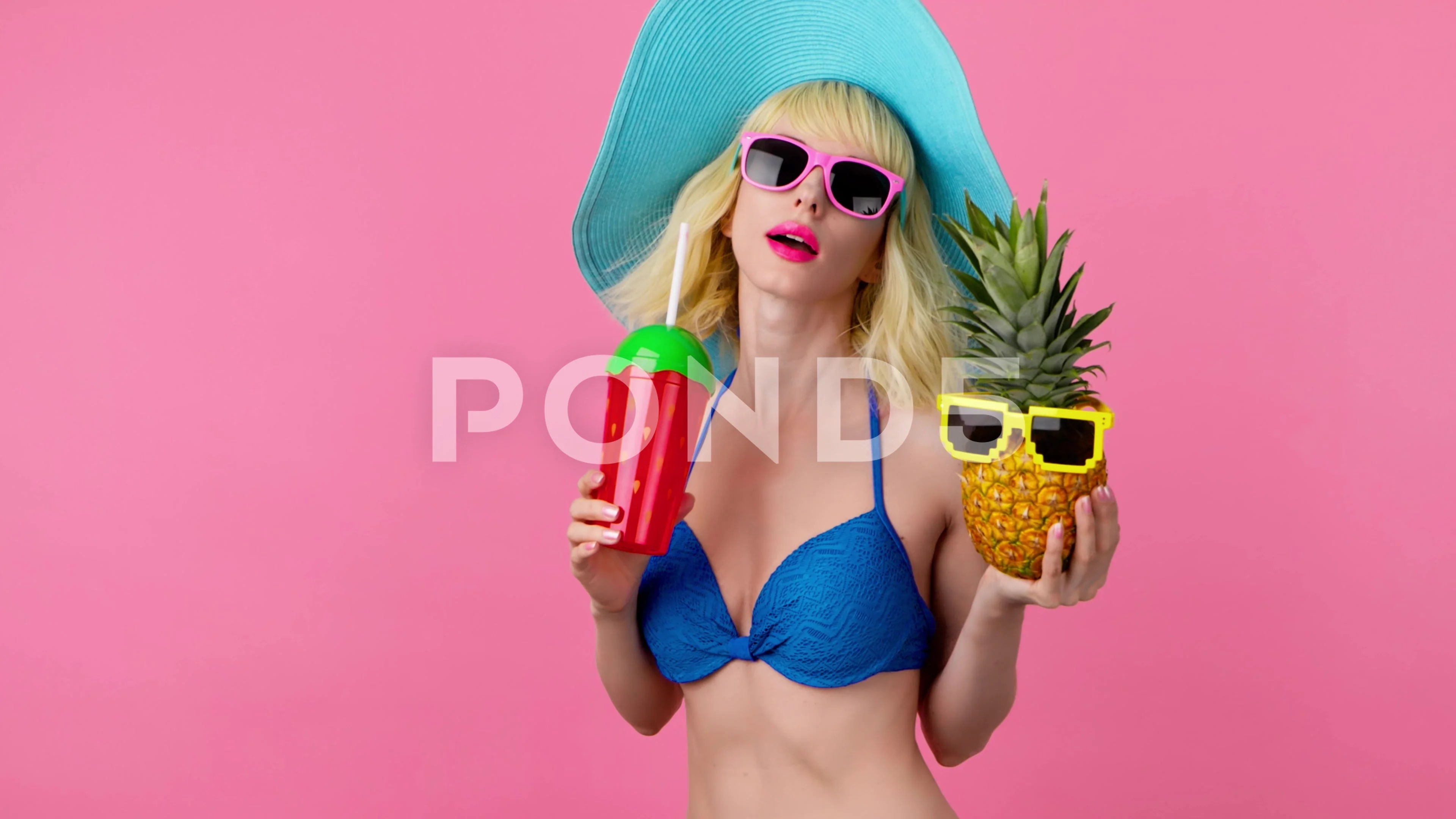 Sexy woman in bikini dancing, tongue out, fashionable hat with pineapple,  smilin