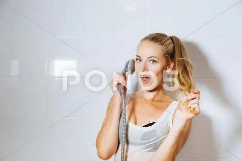 Sexy woman calling the shower-hose Stock Photos
