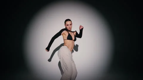 Sexy woman dancing performing hip hop dance in light spot strobe flashing lights Stock Footage 275051753