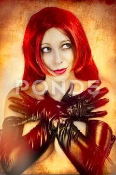 Sexy woman with latex gloves over orange background Stock Photos