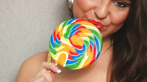 Sexy woman licking sriped lollipop - close up crop Stock Footage