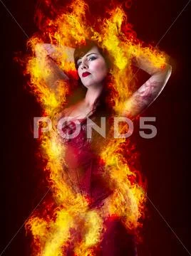 Sexy woman with lingerie over fire backdrop Stock Photos