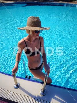 Po of a sexy girl in bikini on swimming pool. Stock Photo