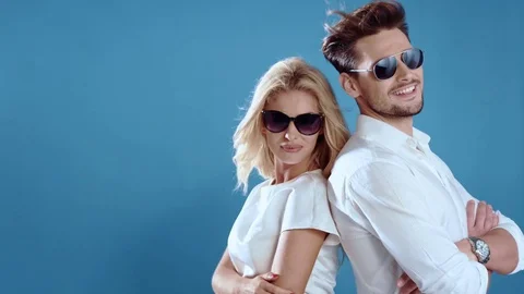 Sexy young couple posing on studio background, 4k slow motion studio clip Stock Footage