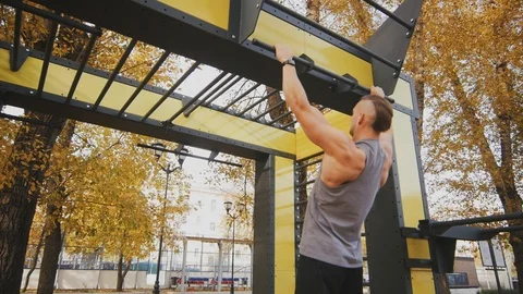 Sexy young man doing pull-ups Stock Footage 96771566