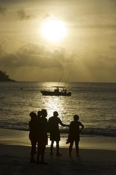 Seychelles-shark Attack On British Man Ian Redmond. A Sunset Vigil By Locals And Stock Photos