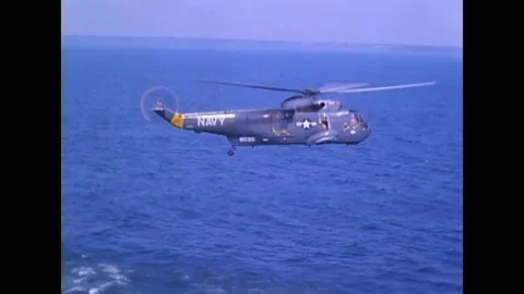 SH-3A helicopter lowers a sonar bells into water and lifts off with sonar bell Stock Footage 117054460