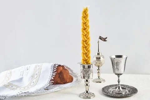 Shabbat Table Setting. Challah bread, braided candle and silver Kiddush cup, Stock Photos