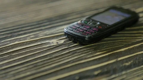Shabby mobile phone on the texture table Stock Footage 81243008