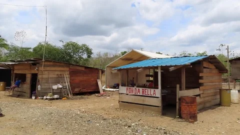 Shacks used for shops in underdeveloped unpaved town Stock Footage 111233685