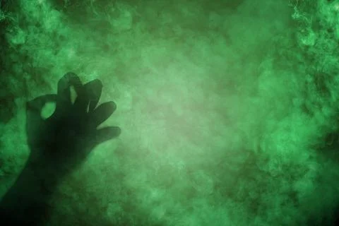Shade of witch hands on dark background. The hand appearing to be devil, ev.. Foto stock