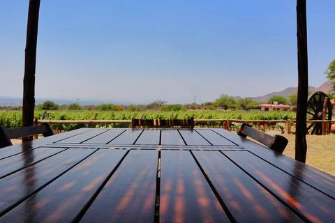 Shaded dining table at Bodega Las Nubles vineyard with mountain backdrop Stock Photos