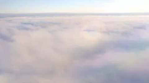 The shadow of the airplane in the clouds, glare from the sun's rays 動画素材 83325695