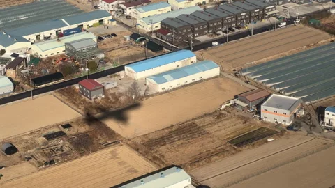 The shadow of an airplane seen over rice fields and fields Видео 172004253