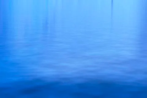 Shadow and light - abstract blue background on a water surface Stock Photos