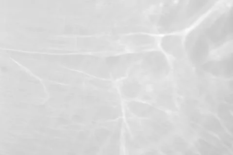 Shadow and light caustic effect on a white wall Stock Photos