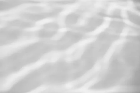 Shadow and light caustic effect on a white wall Stock Photos