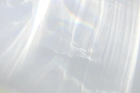 Shadow and light caustic effect on a white wall Stock Photos