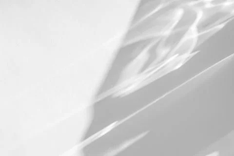 Shadow and light caustic effect on a white wall Stock Photos