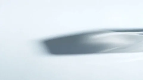 Shadow and light refraction moving across white surface Stock Footage