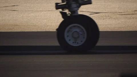 Shadow and Wheels of large passenger jet airliner rolls by on hot airport runway 스톡 동영상 115516038
