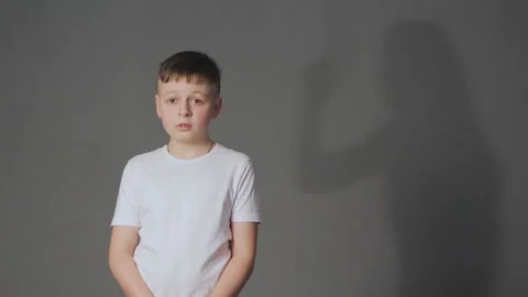 Shadow of angry mother scolds crying son. Domestic violence and children abuse Video stock 88557955