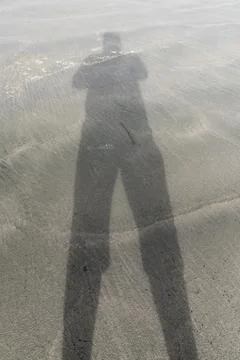 Shadow on the beach Stock Photos