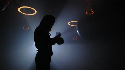 Shadow of the beard boxer man rides the boxing gloves before the training in the Stock Footage 212362353
