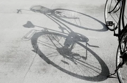Shadow of Bicycle on Concrete Ground Stock Photos