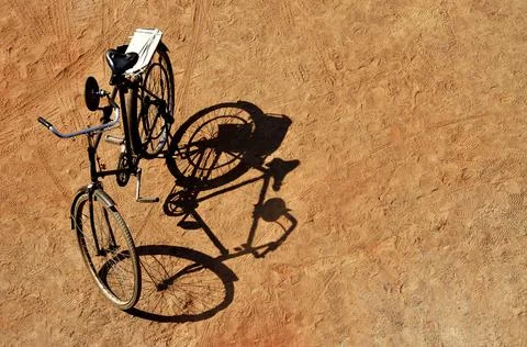 Shadow of a bicycle on sand Stock Photos