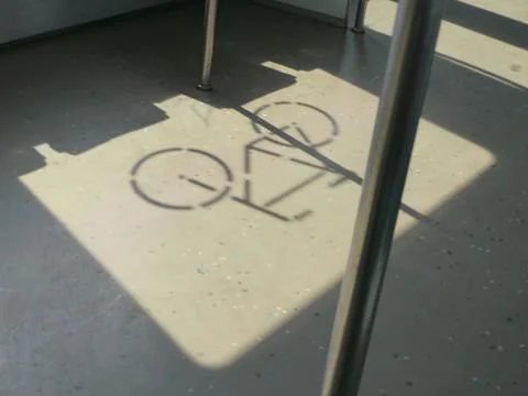 Shadow of a bicycle symbol in the train on the floor Stock Photos