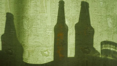 Shadow from the bottles on the moving fabric. Stock Footage 116559867