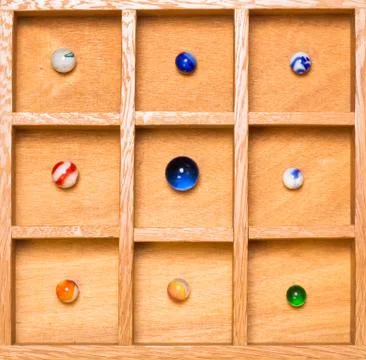 Shadow box with collection of marbles Stock Photos