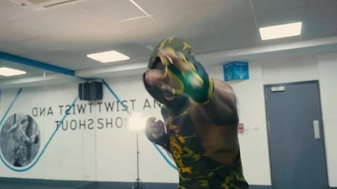 Shadow boxing moves performed to camera wide angle, body builder/boxer Stock Footage 89577600