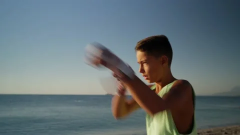 Shadow boxing. Young boy doing boxing workout outdoor in the morning Stock Footage 210719974