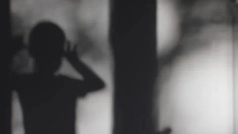 Shadow of boy on gray wall creating playful imagery games of light and shadow Video stock 295002931