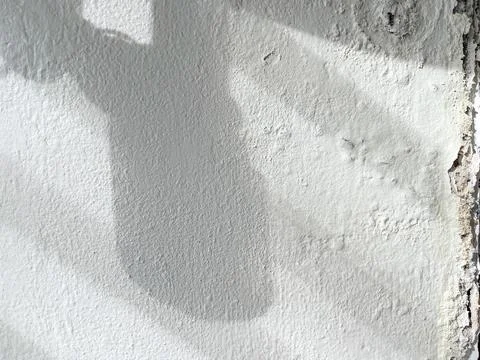 Shadow of broken washbasin drain pipe on damped, musty old painted wall Stock Photos