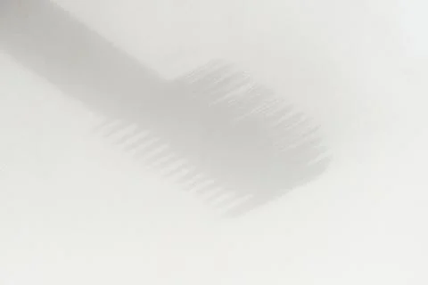 Shadow from a brush for cosmetics on a light background Stock Photos