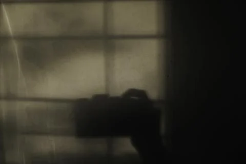 Shadow of camera on the empty wall Stock Photos